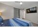 Bedroom with blue bedding and view of the sliding mirror closet doors at 2656 N 84Th Pl, Scottsdale, AZ 85257