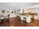 Spacious kitchen with white cabinets, an island counter, and an adjacent dining area at 2656 N 84Th Pl, Scottsdale, AZ 85257