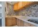 Compact kitchen featuring a tiled backsplash, wooden cabinets, and a white countertop at 2656 N 84Th Pl, Scottsdale, AZ 85257