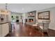 Open-concept living area featuring hardwood floors, a cozy fireplace, and access to the backyard pool at 2656 N 84Th Pl, Scottsdale, AZ 85257