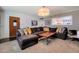 Bright living room with a sectional sofa, artwork, and views into the adjacent updated kitchen at 2656 N 84Th Pl, Scottsdale, AZ 85257