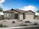 Charming single-story home showcasing brick accents, a three-car garage, and desert landscaping at 278 W Flax Dr, San Tan Valley, AZ 85140