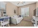 This cozy bedroom is furnished with a trundle daybed, a bright window with shade, a desk, and a TV at 3349 E Merlot St, Gilbert, AZ 85298