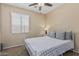 The bedroom features great natural light, neutral paint, carpet, and a cozy queen bed at 3349 E Merlot St, Gilbert, AZ 85298