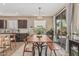 Bright dining area featuring a long wood table, chairs, and sliding glass doors to the backyard at 3349 E Merlot St, Gilbert, AZ 85298