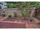 Charming backyard featuring mature landscaping, decorative garden art, and a brick-paved area for outdoor enjoyment at 3510 E Hampton Ave # 74, Mesa, AZ 85204