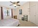 Cozy bedroom featuring a ceiling fan, large window with sheer curtains, and neutral-colored walls at 3510 E Hampton Ave # 74, Mesa, AZ 85204