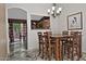 Inviting dining room with a modern chandelier and an open view to the kitchen at 3510 E Hampton Ave # 74, Mesa, AZ 85204