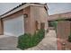 Charming home featuring a white garage door, terra cotta tile roof, and tasteful landscaping at 3510 E Hampton Ave # 74, Mesa, AZ 85204