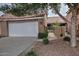 Charming home featuring a white garage door, terra cotta tile roof, and tasteful landscaping at 3510 E Hampton Ave # 74, Mesa, AZ 85204