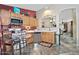 Bright kitchen with warm wood cabinets, tile floors, and view to the dining and living areas at 3510 E Hampton Ave # 74, Mesa, AZ 85204