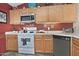 Functional kitchen featuring ample counter space, white appliances, and tile flooring at 3510 E Hampton Ave # 74, Mesa, AZ 85204