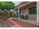 Relaxing covered patio with seating area, barbecue grill, and mature landscaping creating a welcoming outdoor space at 3510 E Hampton Ave # 74, Mesa, AZ 85204