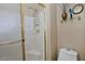 Shower features white tiles, glass doors, and shelving for convenient storage at 3510 E Hampton Ave # 74, Mesa, AZ 85204