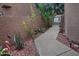 A landscaped walkway leads through a gated courtyard with desert plants at 3510 E Hampton Ave # 74, Mesa, AZ 85204