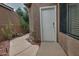 A landscaped walkway leads to a white back door with desert plants at 3510 E Hampton Ave # 74, Mesa, AZ 85204
