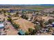 Expansive aerial showcasing the property with horse amenities and residential structures at 3738 E Hash Knife Draw Rd, Queen Creek, AZ 85140