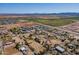 Wide aerial shot showcasing the property's rural setting and vast farmland nearby, offering a tranquil lifestyle at 3738 E Hash Knife Draw Rd, Queen Creek, AZ 85140