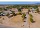 Spacious aerial view showing a sprawling lot, landscaping, and various structures on the property at 3738 E Hash Knife Draw Rd, Queen Creek, AZ 85140