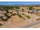 Wide aerial view showcasing the expansive property with horse paddocks and mature landscaping at 3738 E Hash Knife Draw Rd, Queen Creek, AZ 85140