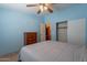 Bedroom featuring a ceiling fan, en suite access, dresser, and closet at 3738 E Hash Knife Draw Rd, Queen Creek, AZ 85140