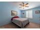 Bright bedroom with a ceiling fan, window with shutters, and neutral decor at 3738 E Hash Knife Draw Rd, Queen Creek, AZ 85140