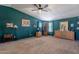 Spacious bedroom with green accent wall, bay windows, and carpet flooring at 3738 E Hash Knife Draw Rd, Queen Creek, AZ 85140