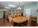 Inviting dining room featuring wood table and chairs under a decorative light fixture at 3738 E Hash Knife Draw Rd, Queen Creek, AZ 85140