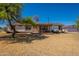 Charming single-story home with a welcoming front porch and a spacious front yard at 3738 E Hash Knife Draw Rd, Queen Creek, AZ 85140