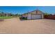 Detached two-car garage with ample parking space and an adjacent covered structure at 3738 E Hash Knife Draw Rd, Queen Creek, AZ 85140