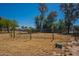 Spacious horse paddock with a metal gate and grassy area at 3738 E Hash Knife Draw Rd, Queen Creek, AZ 85140