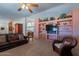 Bright living room with large entertainment center and comfortable seating area at 3738 E Hash Knife Draw Rd, Queen Creek, AZ 85140