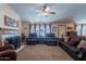 Cozy living room features plush seating, a fireplace, and bright natural light at 3738 E Hash Knife Draw Rd, Queen Creek, AZ 85140