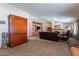 Spacious living room featuring a cozy fireplace and built-in shelving at 3738 E Hash Knife Draw Rd, Queen Creek, AZ 85140