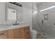Modern bathroom with marble-style shower, a wood vanity, and stylish fixtures at 39302 N 30Th Dr, Phoenix, AZ 85086