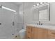 Elegant bathroom with white marble shower and a wood vanity, featuring modern design at 39302 N 30Th Dr, Phoenix, AZ 85086