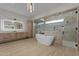 Luxurious bathroom featuring a freestanding tub, marble shower with glass doors, and a custom vanity at 39302 N 30Th Dr, Phoenix, AZ 85086