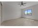 Spacious bedroom with wood-look tile flooring, a ceiling fan, and a large window for natural light at 39302 N 30Th Dr, Phoenix, AZ 85086