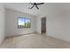 Bright bedroom featuring light wood flooring, a modern ceiling fan, and a large window with backyard views at 39302 N 30Th Dr, Phoenix, AZ 85086