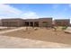 A stunning, desert-landscaped single-story home features a clean modern aesthetic and three-car garage at 39302 N 30Th Dr, Phoenix, AZ 85086