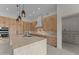 Gourmet kitchen with marble island, sleek cabinetry, pendant lighting, and stainless steel appliances at 39302 N 30Th Dr, Phoenix, AZ 85086