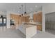 Modern kitchen featuring a large island with a marble countertop, custom cabinets, and stainless steel appliances at 39302 N 30Th Dr, Phoenix, AZ 85086