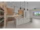 Open kitchen featuring an island with seating, modern appliances, wood cabinets, and bright lighting at 39302 N 30Th Dr, Phoenix, AZ 85086