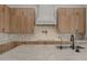 Bright kitchen featuring marble countertops, modern fixtures, tile backsplash, and custom wood cabinets at 39302 N 30Th Dr, Phoenix, AZ 85086