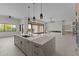Open-concept living space includes a modern kitchen with an island and sliding glass doors to the outside at 39302 N 30Th Dr, Phoenix, AZ 85086