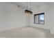An airy living room features modern light fixture, tile floors, and large windows at 39302 N 30Th Dr, Phoenix, AZ 85086