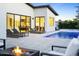 Modern backyard featuring a pool, lounge chairs, and a fire pit with views into the home at 4002 N 33Rd Pl, Phoenix, AZ 85018