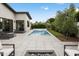 Beautiful backyard with a refreshing pool, cozy lounge seating, and a modern fire pit feature at 4002 N 33Rd Pl, Phoenix, AZ 85018