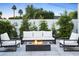 Inviting outdoor space with a modern fire pit surrounded by comfortable seating and lush greenery at 4002 N 33Rd Pl, Phoenix, AZ 85018