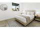 Cozy bedroom with a plush bed, decorative rug, and a window offering neighborhood views at 4002 N 33Rd Pl, Phoenix, AZ 85018